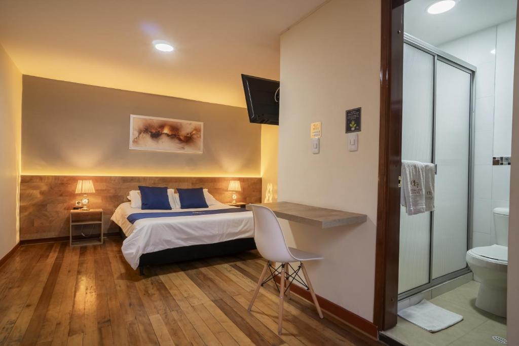 a bedroom with a bed and a sink and a toilet at Hotel Catedral Boutique Loft in Pasto