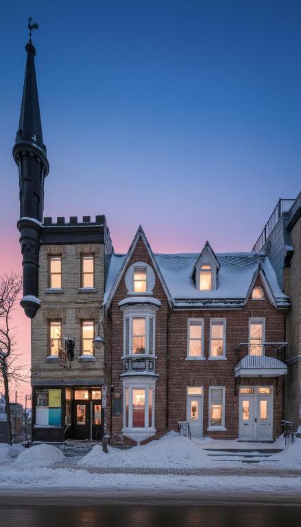 a large brick building with a clock tower at Auberge Château Des Tourelles - Par Aneyro in Quebec City