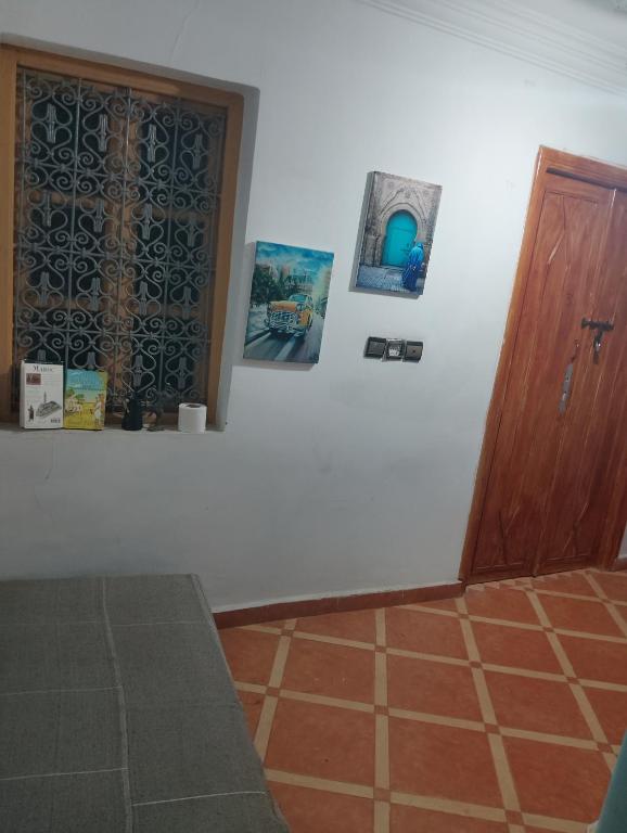 a room with a door and pictures on the wall at Marrakesh Classic House 20 in Marrakesh
