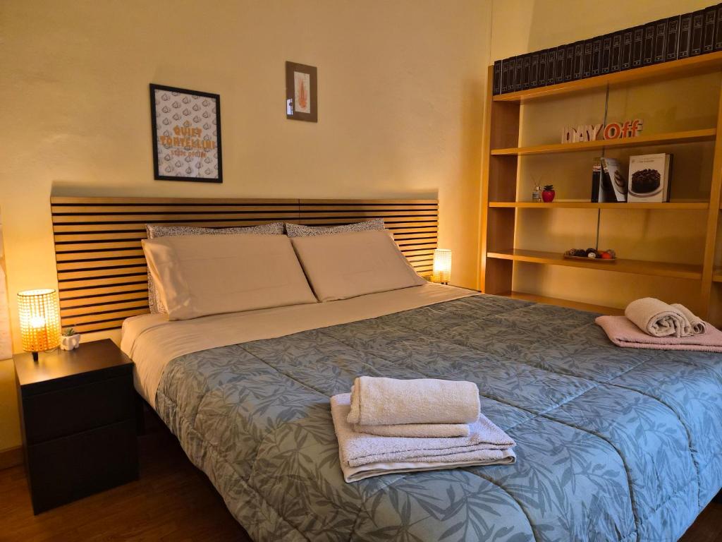 a bedroom with a bed with two towels on it at Quiet Tortellini in Modena