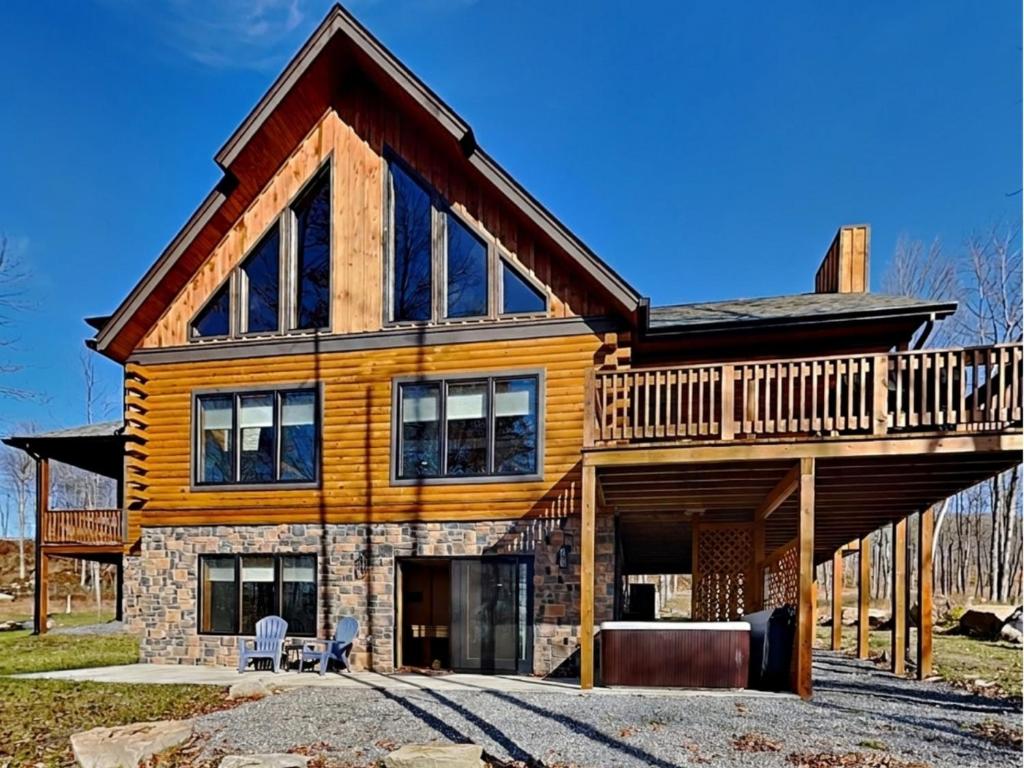 a log home with a wrap around deck at Golden Crest in McHenry