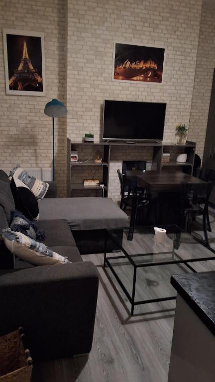 a living room with a couch and a piano at Zak Air B&B Stay 9 people's in Birmingham