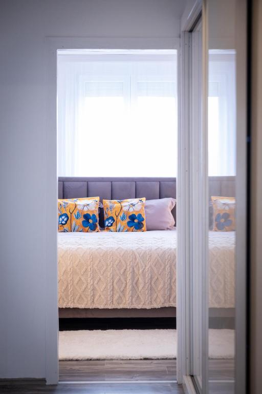 a bedroom with a bed with a window at City Square, center in Subotica
