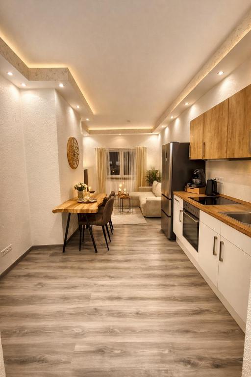 a kitchen with a table and a dining room at CitySuite Borken Hessen in Borken