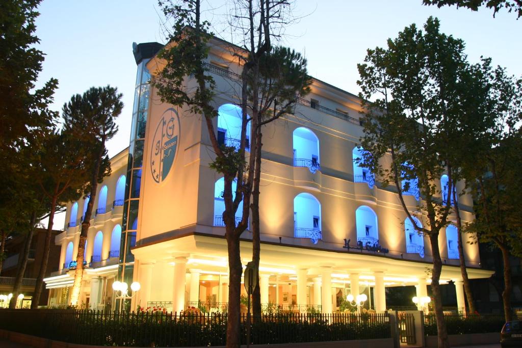 a white building with blue lights on it at Hotel Il Gabbiano in Cesenatico