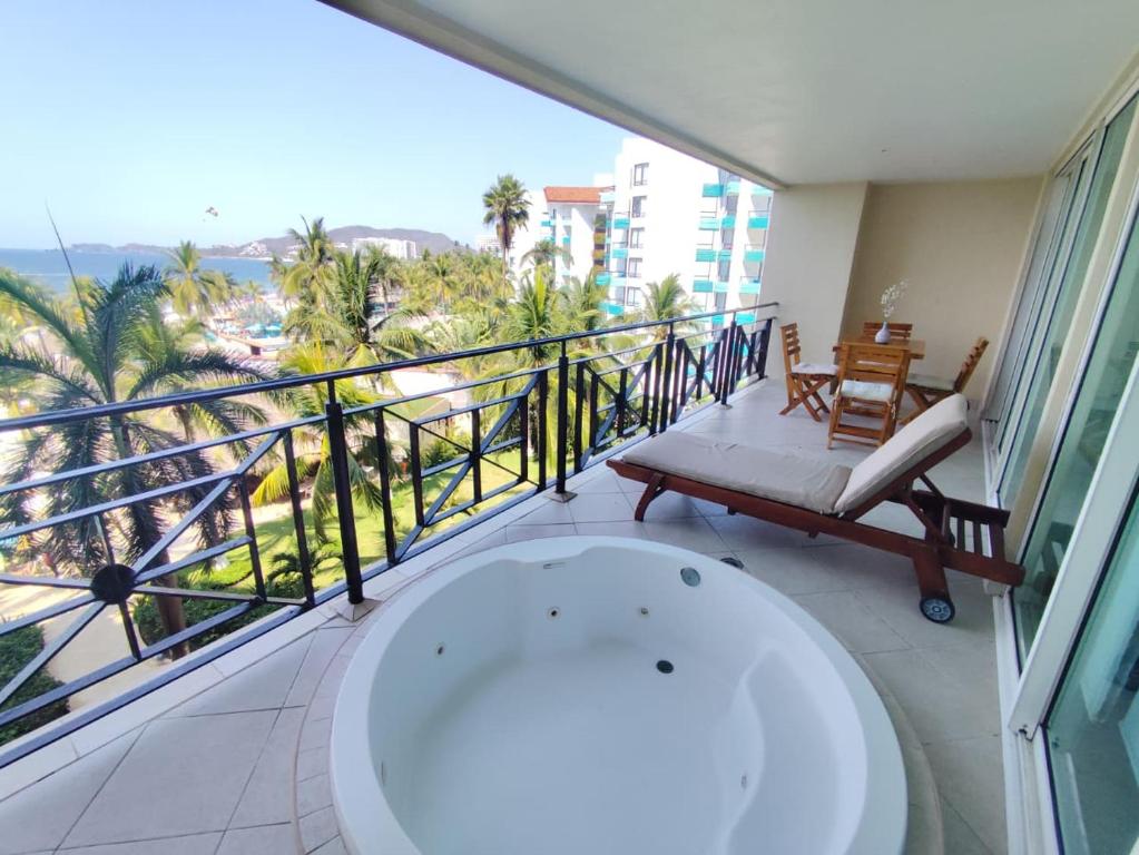 a bathroom with a bath tub and a balcony at IXTAPA LUXURY - BVG 405 Norte in Ixtapa