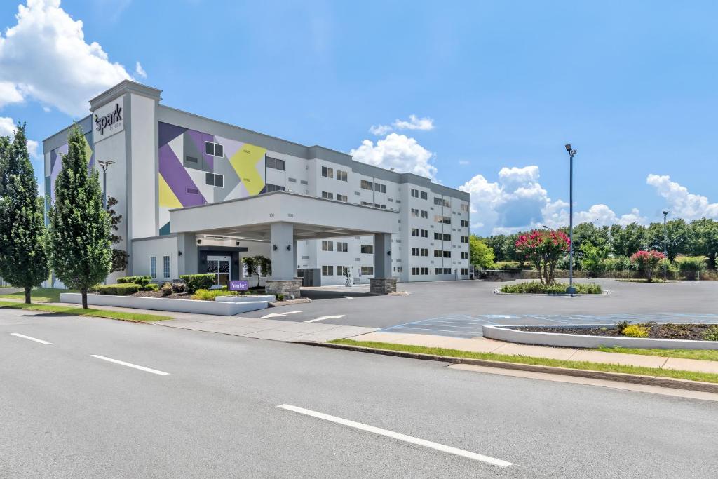 a large white building with a parking lot at Spark by Hilton Chattanooga Downtown in Chattanooga