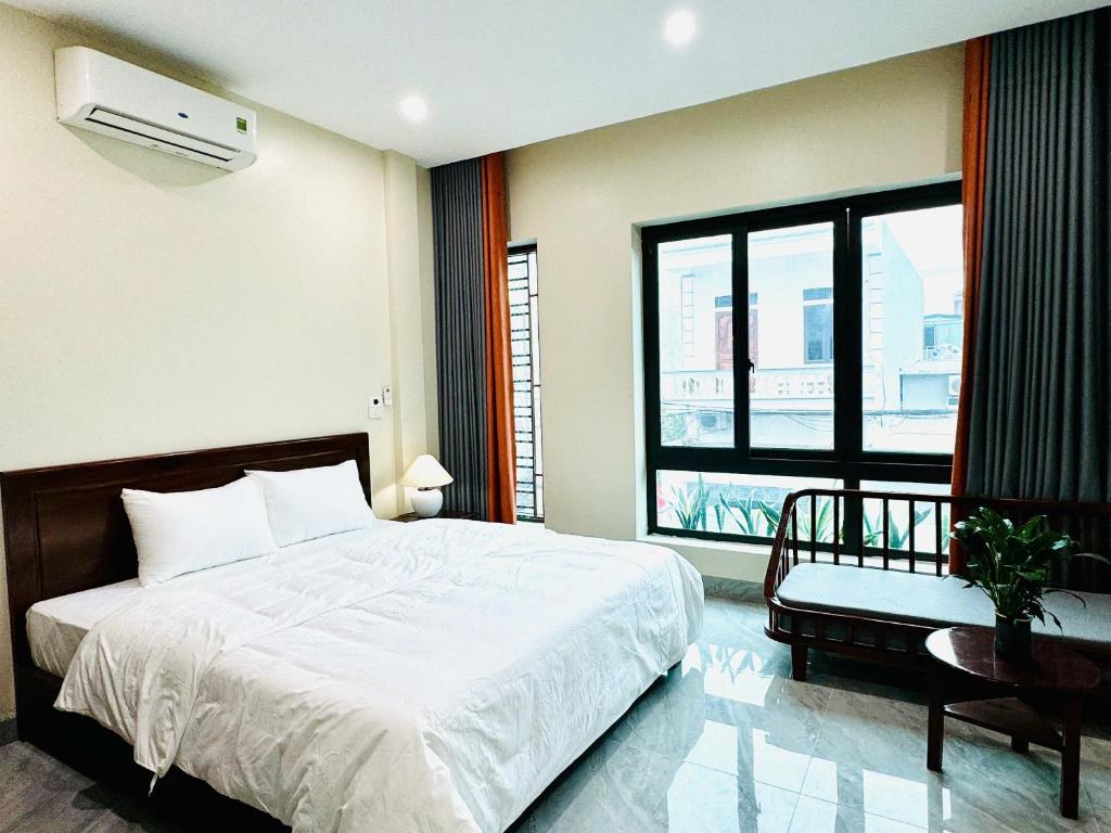 a bedroom with a large bed and a window at An's Home Ninh Binh in Ninh Binh