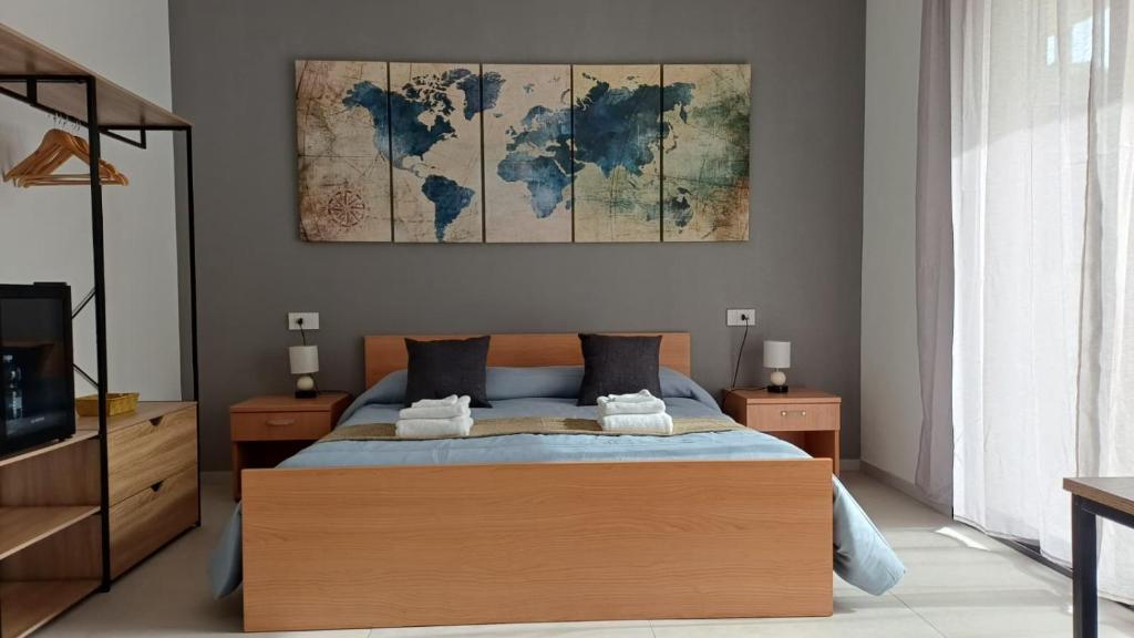 a bedroom with a bed with a world map on the wall at Oris in Oristano
