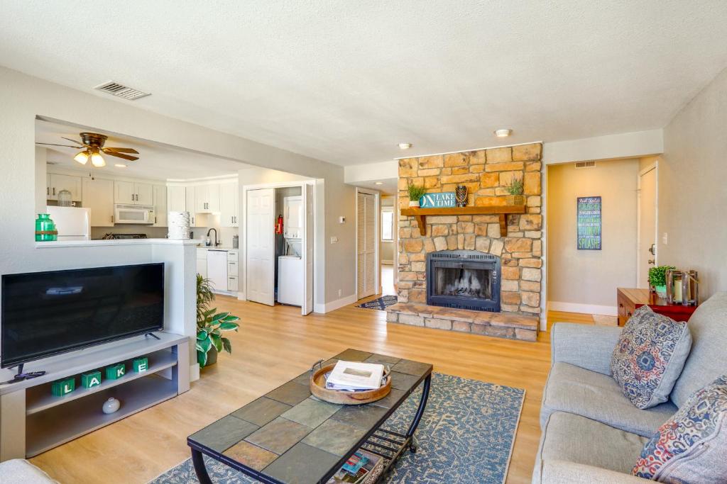 a living room with a tv and a fireplace at Relax Poolside! Lake-View Retreat in Osage Beach in Osage Beach