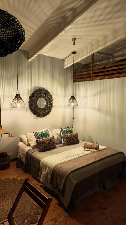a bedroom with a large bed in a room at Tiny House 3 En el río in Linares