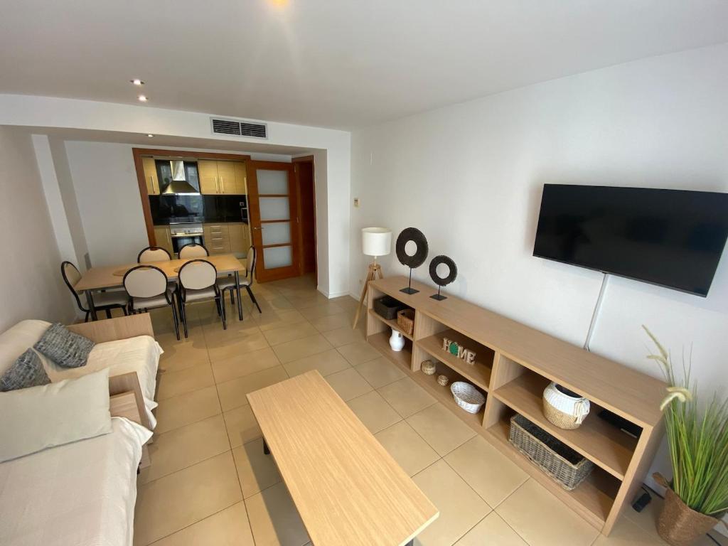 a living room with a couch and a table at Osaka Suite in Lloret de Mar