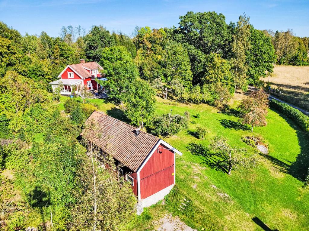 an aerial view of a red barn on a hill next to a river at Villa Äppelgården by Interhome in Örebro