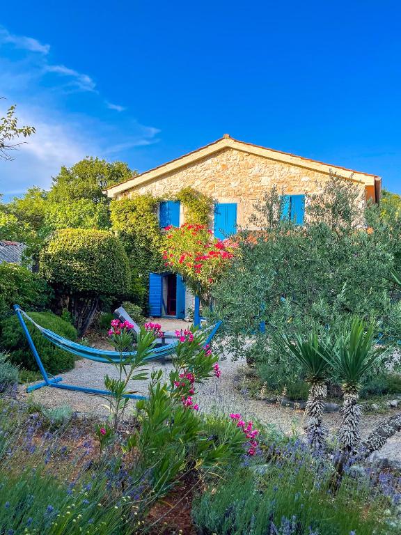 a house with a hammock in front of a garden at Old Stonehouse Stari San in Pinezici