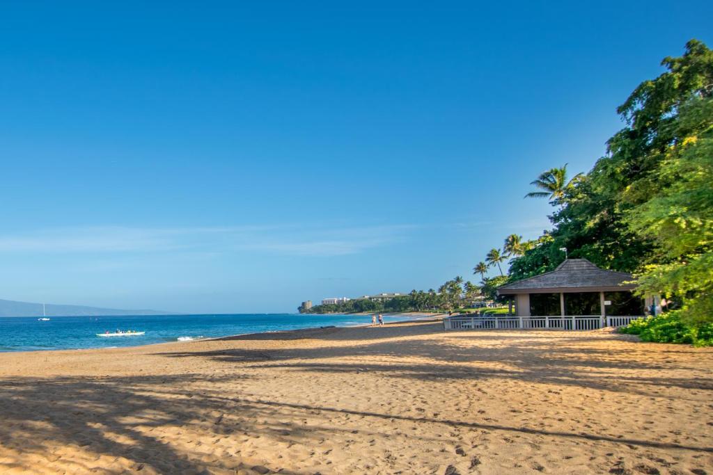 a beach with a gazebo and the ocean at Kaanapali Maui at the Eldorado by OUTRIGGER in Lahaina