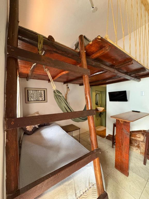 a bunk bed in a room with a table at Casa Ametista in Lençóis