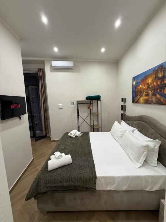 a bedroom with a bed with two towels on it at HV Carbonara 123 in Naples