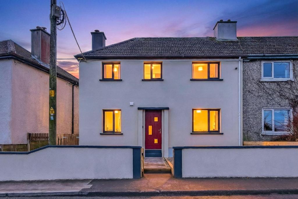 a white house with a red door at Martin Savage in Sligo
