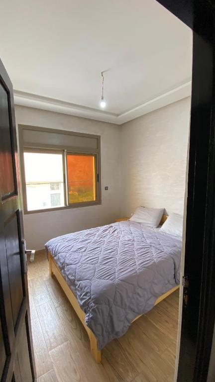 a bedroom with a bed and a window at Blue Drift in Imsouane