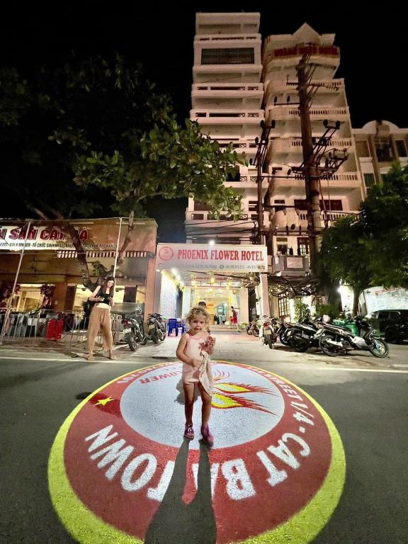 a little child standing on a circle in the street at Phoenix Flower Hotel in Cat Ba