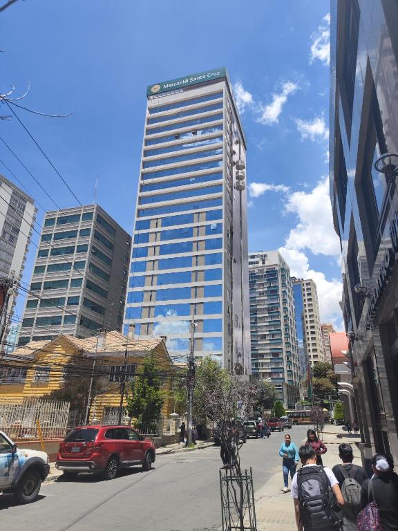 a tall building in the middle of a city at Departamento de lujo 2D Av Arce in La Paz
