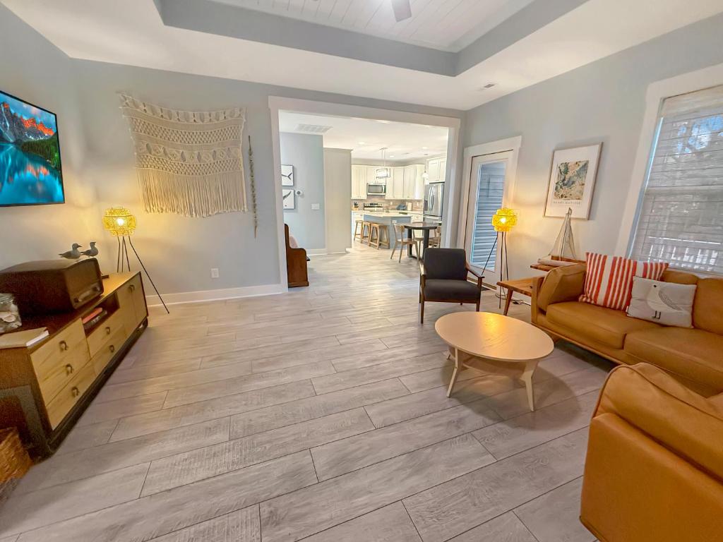 a living room with a couch and a table at Live Oak Cottage OKI Beach Retreat in Oak Island