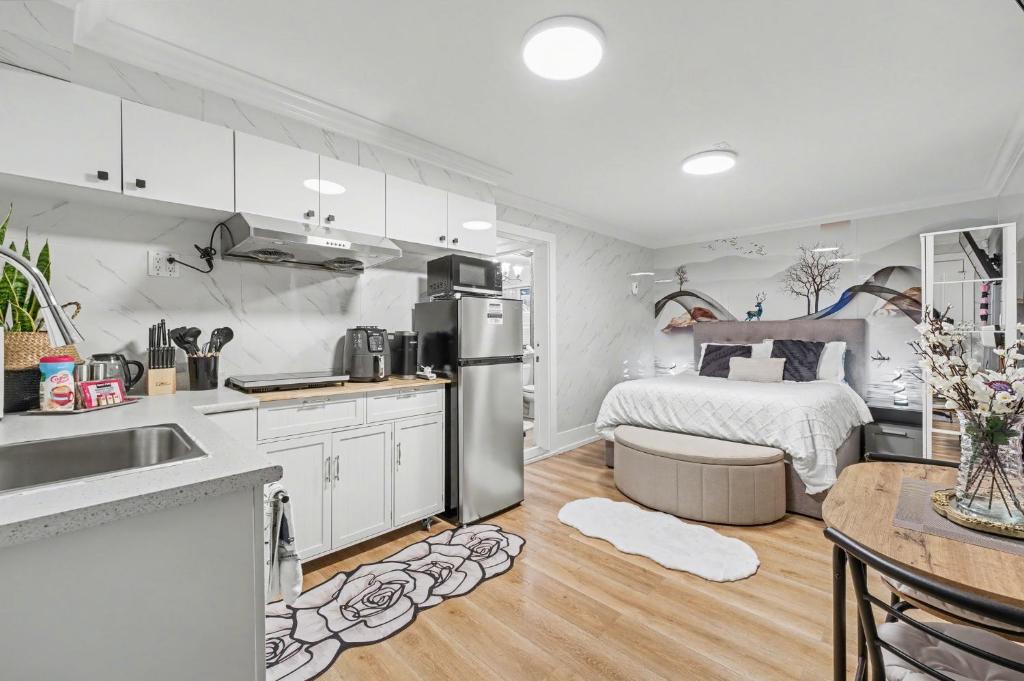 a kitchen and living room with a bed in a room at Secluded Bachelor Suite in Vancouver