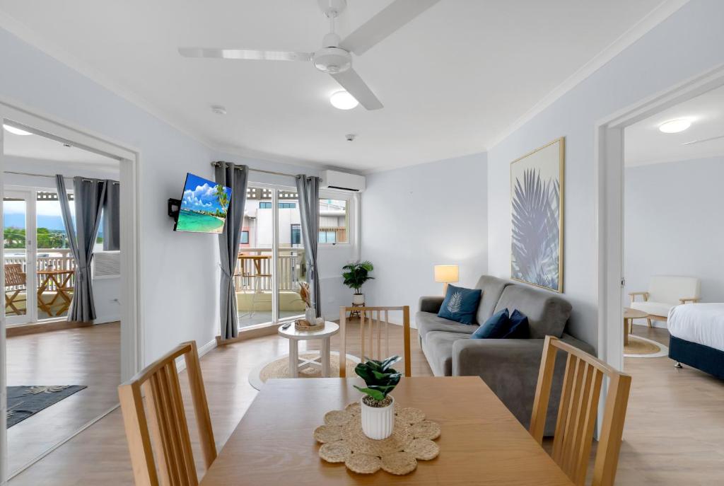 a living room with a table and a couch at Northshore Palms Apartment in Cairns North