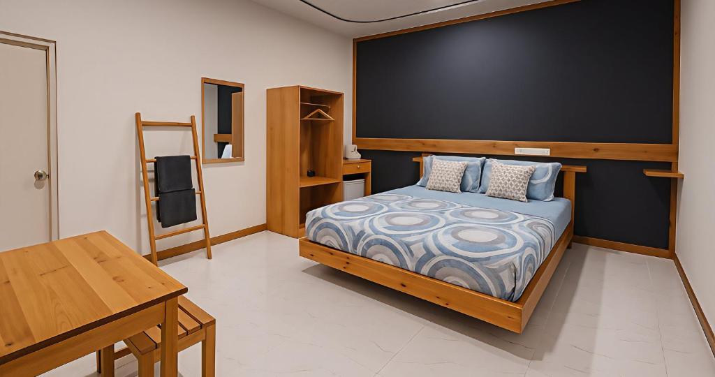 a bedroom with a bed and a large screen at Dhiggaa by H Collection in Huraa