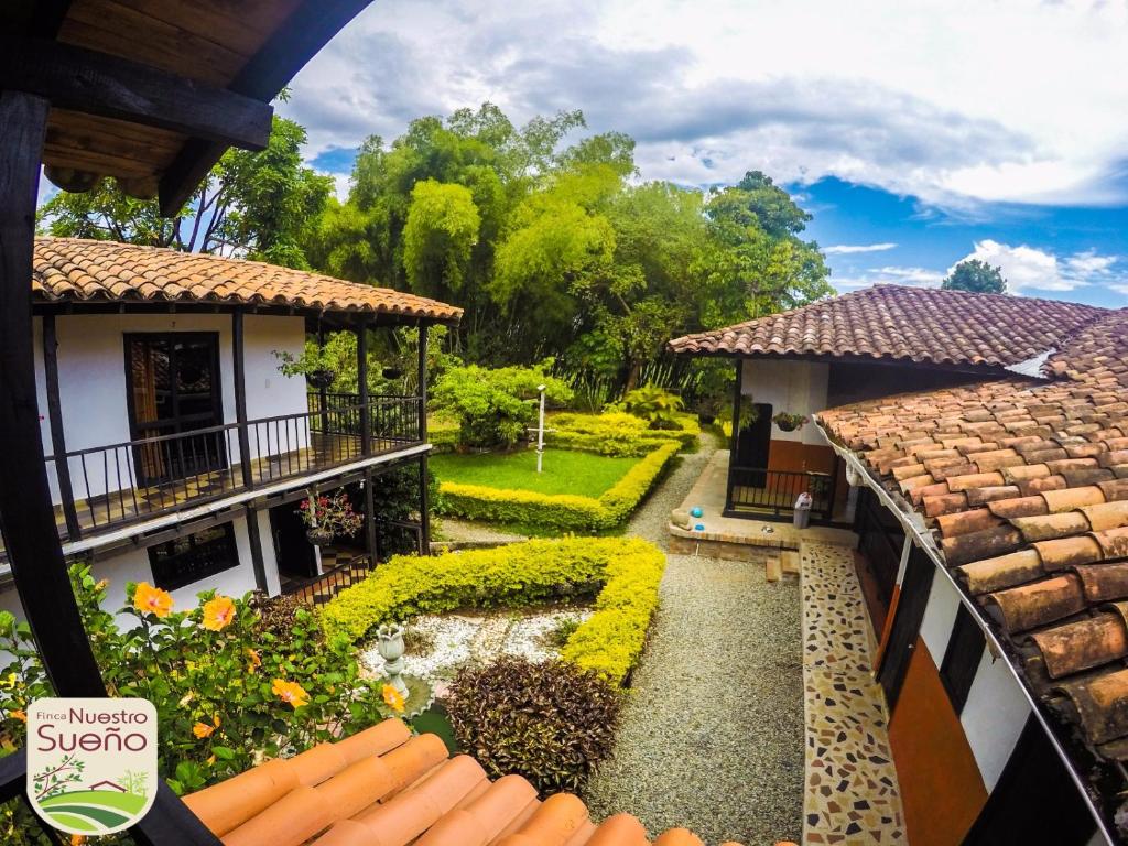 a view of a garden from a balcony of a house at Finca Nuestro Sueño in Quimbaya