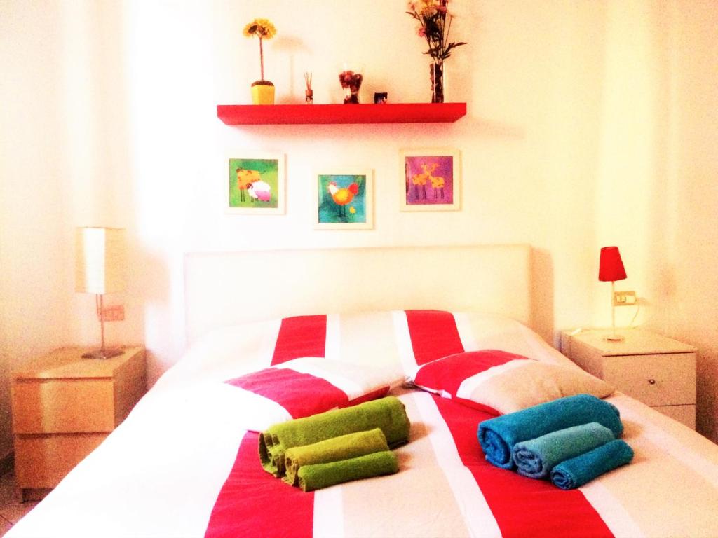 a bedroom with a bed with colorful pillows on it at Apartment With Garden in Lucca