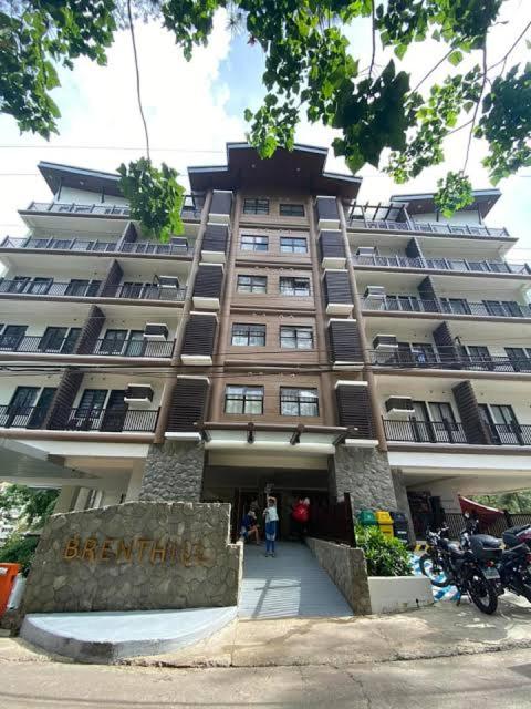 a large building with a sign in front of it at Brenthill Condo Ruby unit in Baguio