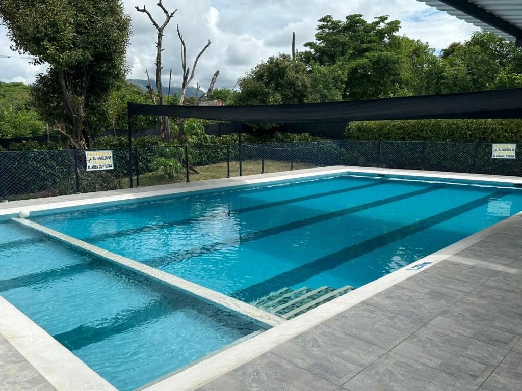 a large swimming pool with blue water at Casa Campestre Kostal Azul in Tocaima