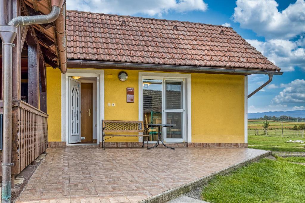 a yellow house with a patio at River View Suite Mlinar Private Beach - Happy Rentals in Metlika