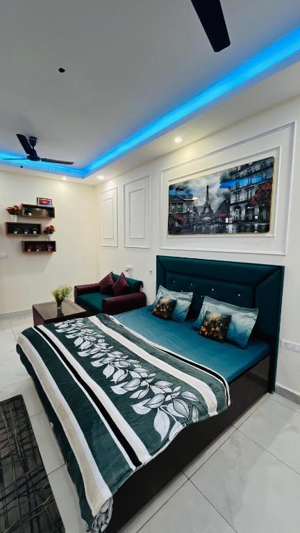 a bed in a room with a blue light at The dream studio in Noida