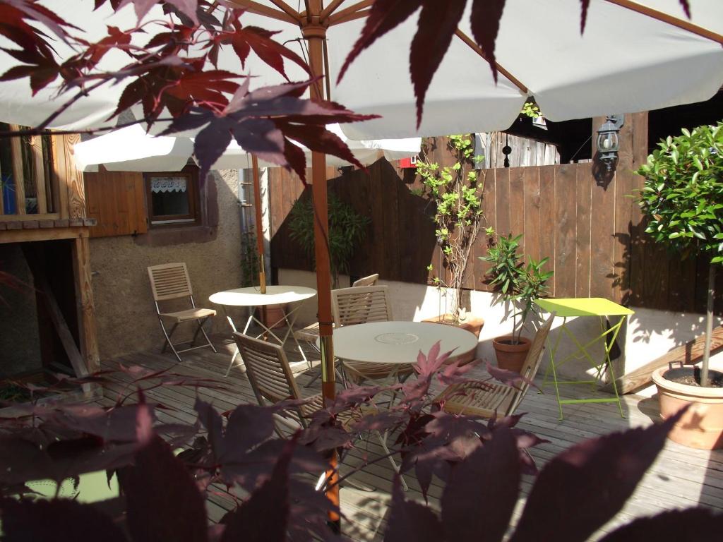 a patio with an umbrella and a table and chairs at Vintage Apartment in Riquewihr with Terrace in Riquewihr