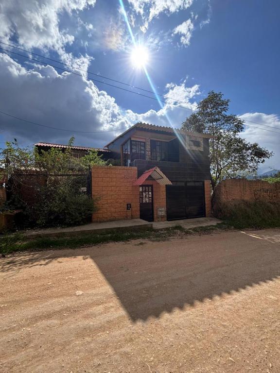 a brick house with the sun in the sky at Cabaña Belvedere in Duitama