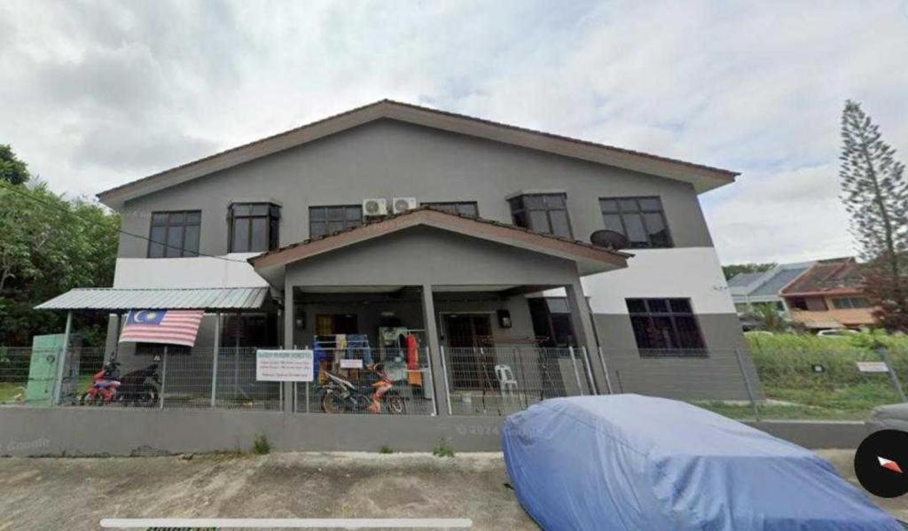 a house with a blue tarp in front of it at Kemas Homestay in Johor Bahru