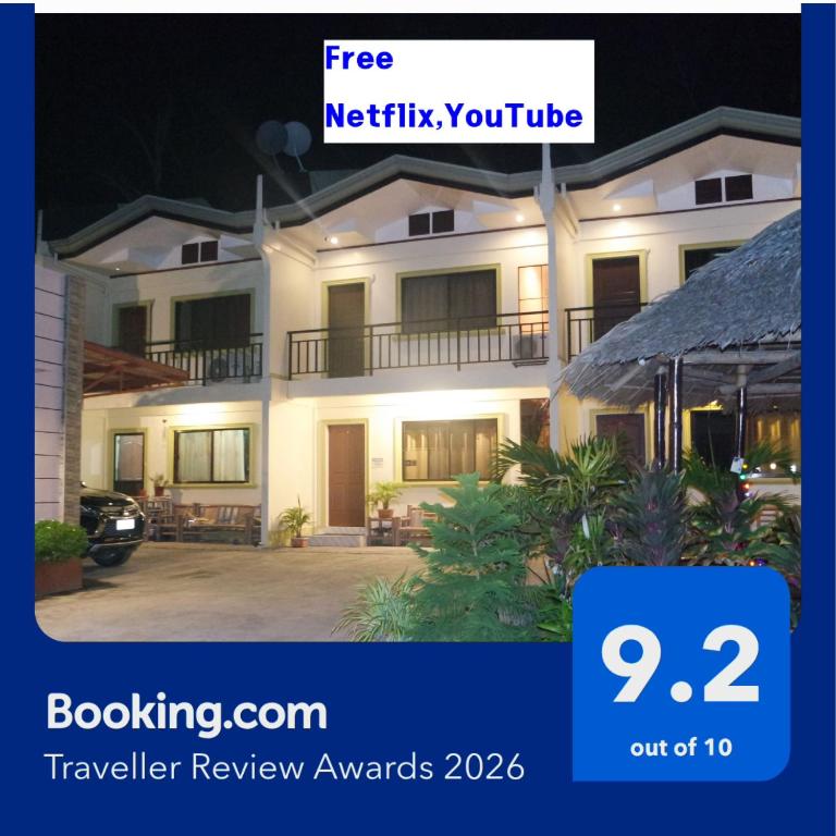 a review of a hotel at night with the hotel advertised at YOO C Apartment - Free Netflix YouTube in Dumaguete