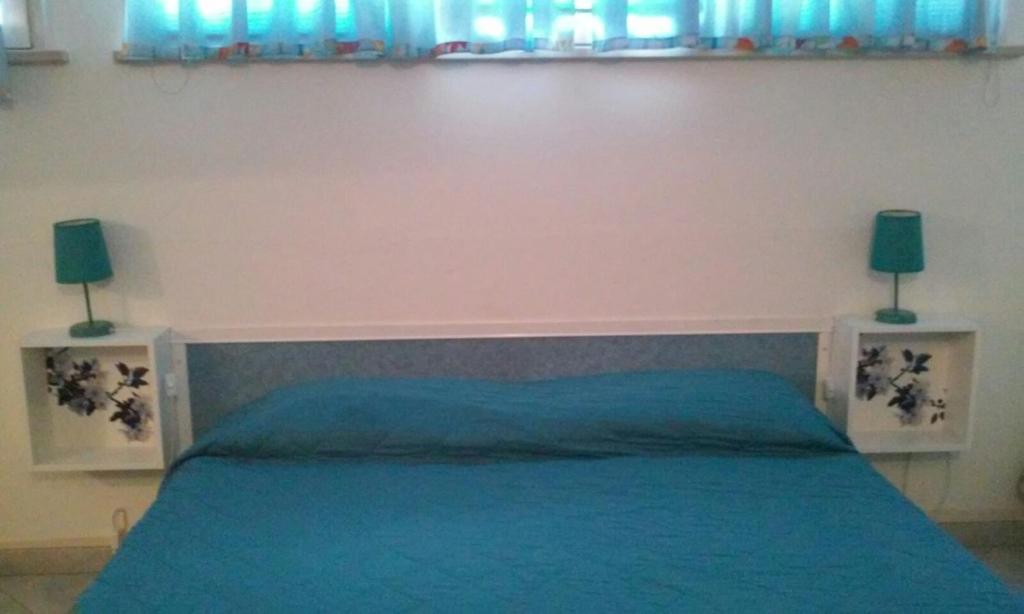 Postel nebo postele na pokoji v ubytování B&B Al Verde & Mare