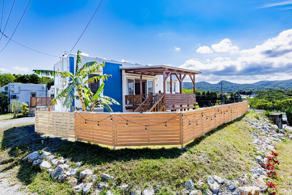 a house with a gazebo on a hill at Unbi Stay in Nakijin