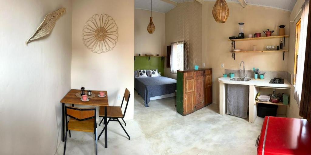 a small kitchen with a table and a sink at Casa Esmeralda in Lençóis