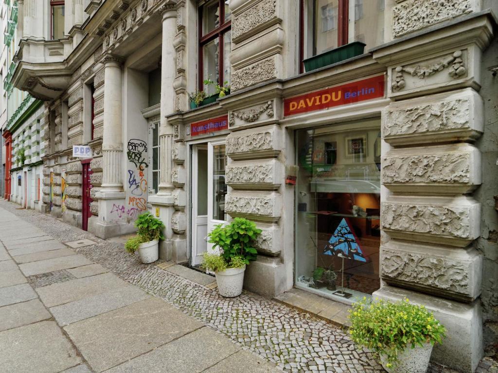 a building with plants in front of a store at Apartment in Kreuzberg with internet in Berlin
