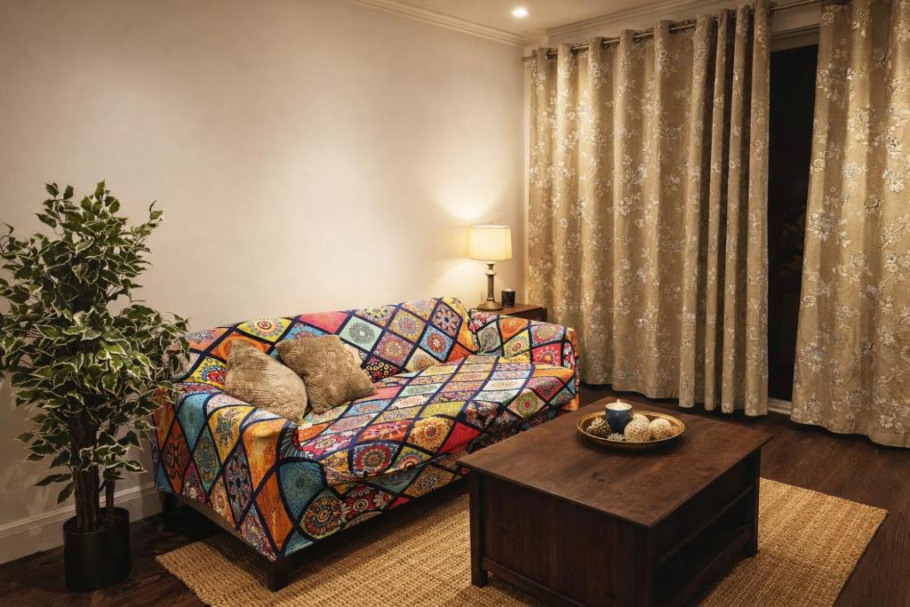 a living room with a couch and a table at Excellent 2 bedroom Apartment- great Connectivity to central london in Barking