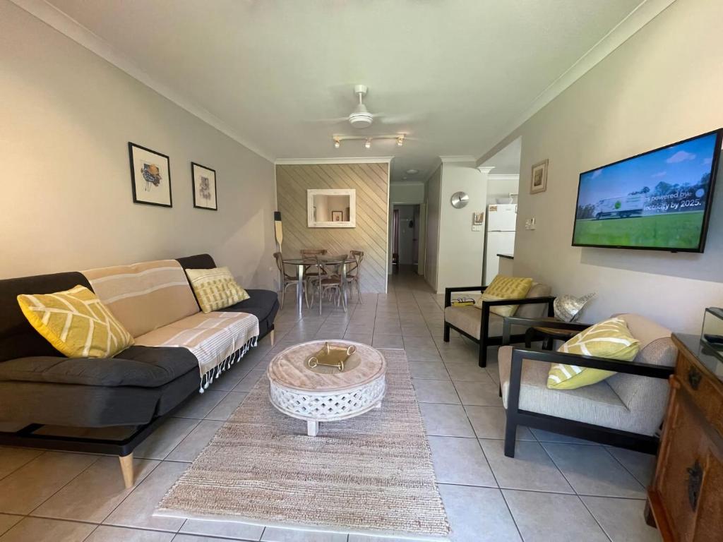 a living room with a couch and a table at Liana 4 Beach Lovers All at your finger tips in Mission Beach