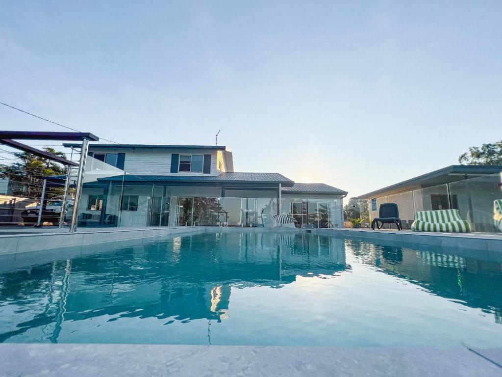 a swimming pool in front of a house at Bella Luna Beach Front 2 bed in South Mission Beach