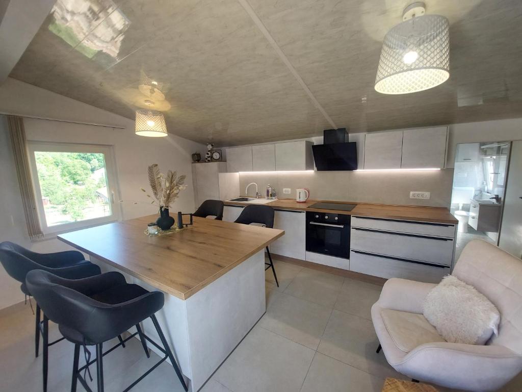 a kitchen with a table and chairs in a room at Ester in Kastav