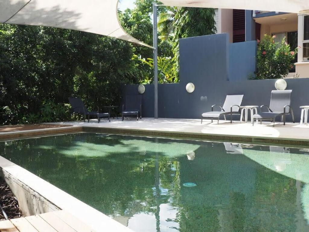 a swimming pool with some chairs and some water at BHA 1 Beachfront Haven fullhouse in Mission Beach