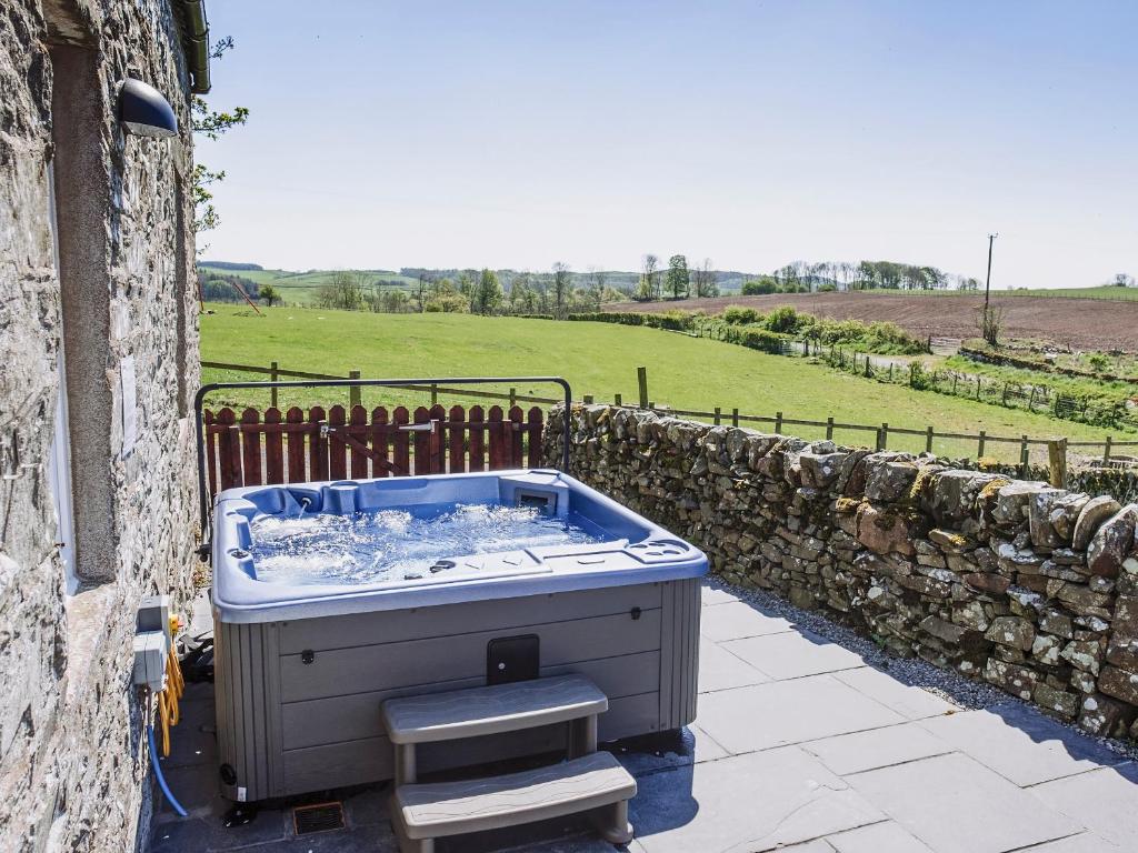 a hot tub sitting on the side of a building at Heron View in Kirkcudbright