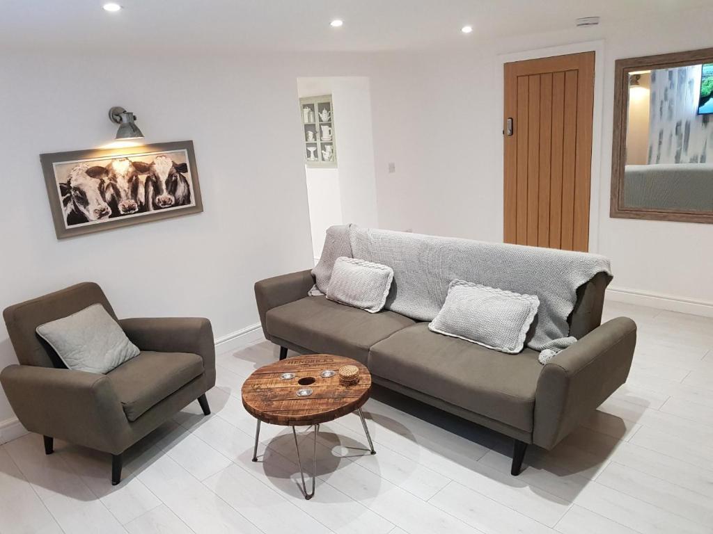 a living room with a couch and a chair and a table at Cottage Apartment - Uk2774 in Llandudno